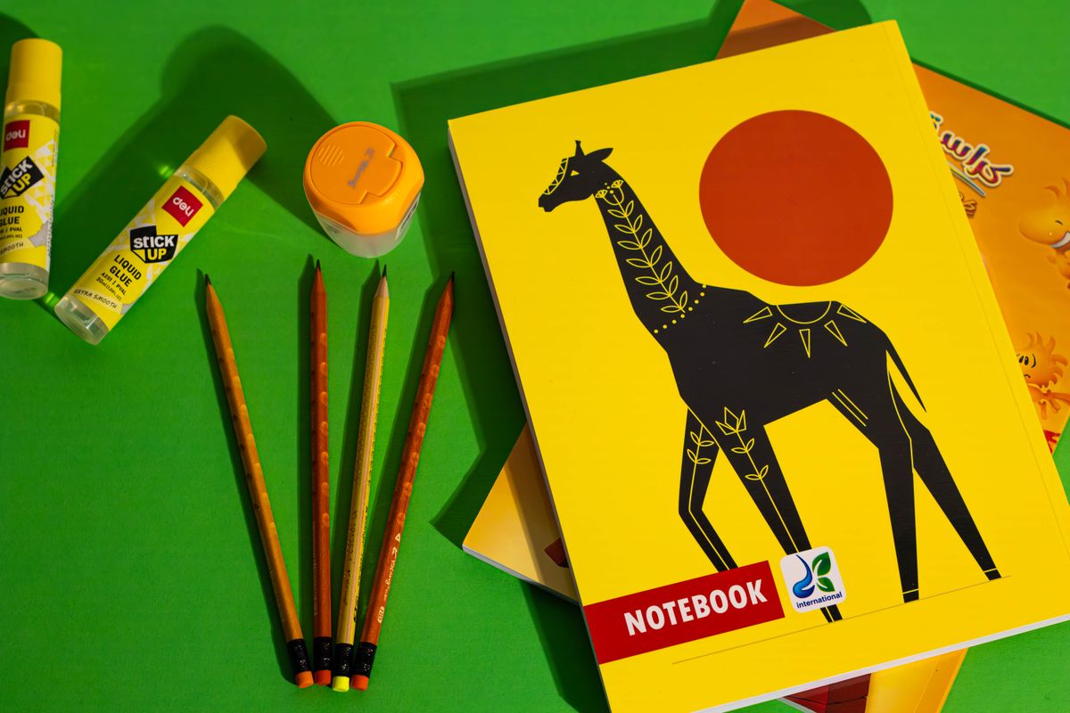 Notebooks, pencils, and other school essentials laid out